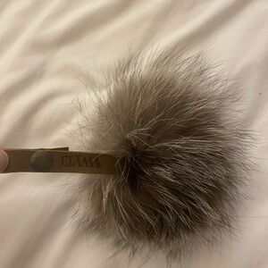 Purse accessory from Maison Elama. Brown leather strap with fake fur.